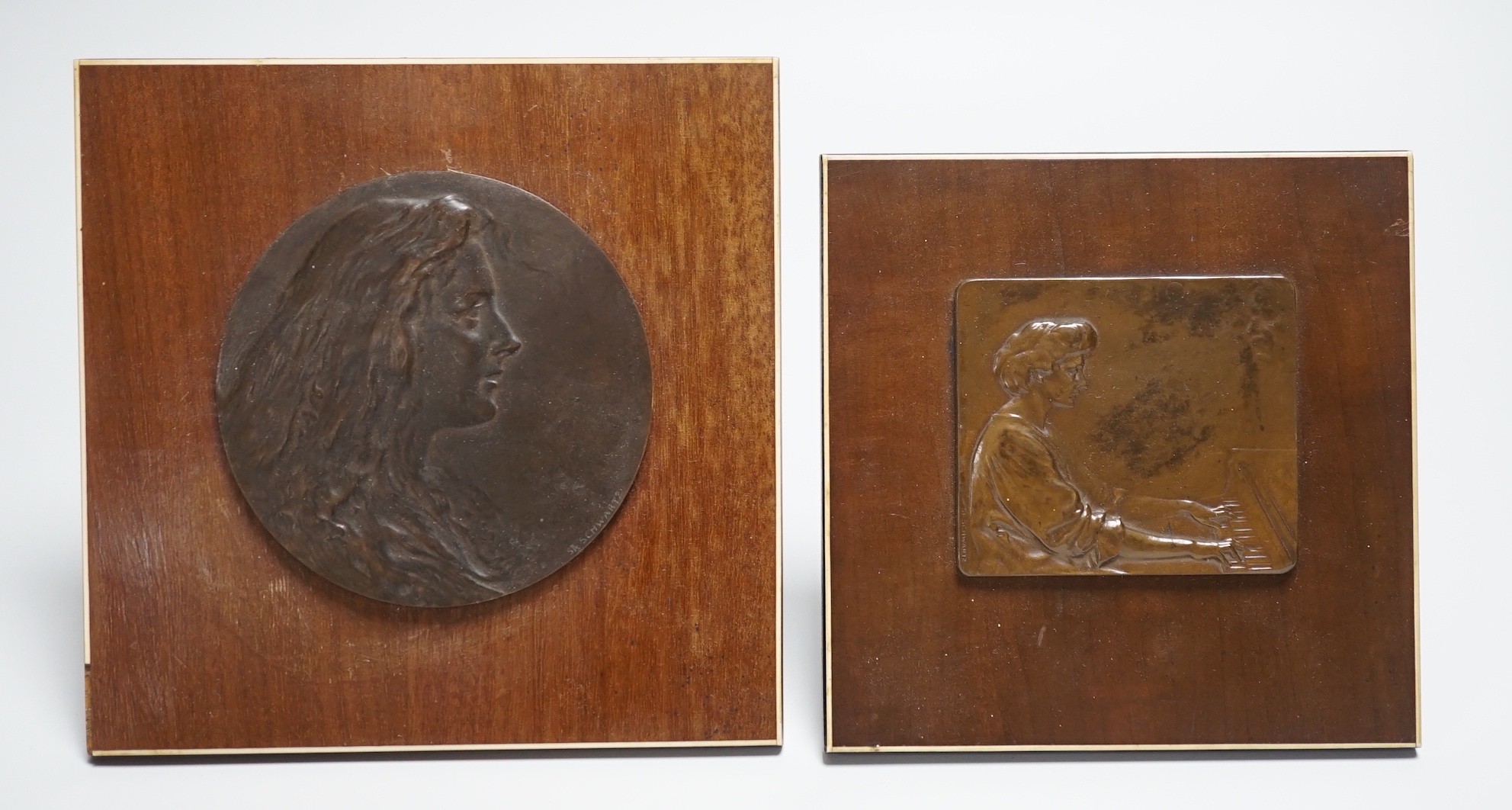 Two Stefan Schwartz bronze relief plaque, mounted on mahogany easels. Largest easel 16cm sq and an Art of Parqueter Mosaic Puzzle, Germany